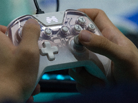 A player is playing with a game controller at Chinajoy games fair in Shanghai, China, on July 26, 2024. (