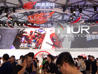 A general view of a crowd of fairgoers is being seen in front of the Netease Games booth at the Chinajoy Games Fair in Shanghai, China, on J...