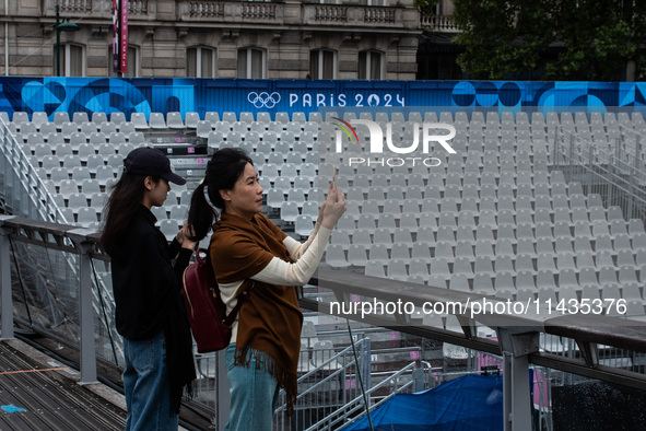 Few tourists are holding tickets for the opening ceremony of the Olympic Games in the center of Paris, France, on the banks of the Seine, in...