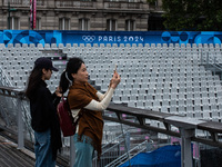 Few tourists are holding tickets for the opening ceremony of the Olympic Games in the center of Paris, France, on the banks of the Seine, in...