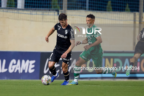 Tomas Handel (L) of Vitoria SC is moving forward with the ball ahead of Matias Garcia (R) of Floriana during the UEFA Europa Conference Leag...