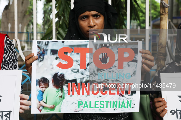 A member of the Indians for Palestine group is holding a poster during a protest, amid the ongoing conflict in Gaza between Israel and Hamas...