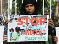 A member of the Indians for Palestine group is holding a poster during a protest, amid the ongoing conflict in Gaza between Israel and Hamas...