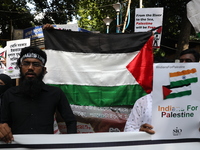 Indians for Palestine group members are holding posters during a protest, amid the ongoing conflict in Gaza between Israel and Hamas, in Kol...