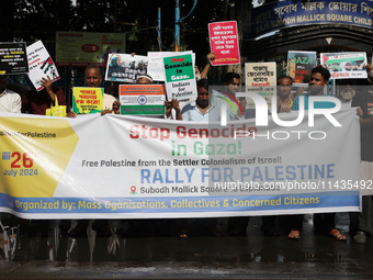 Indians for Palestine group members are holding posters during a protest, amid the ongoing conflict in Gaza between Israel and Hamas, in Kol...