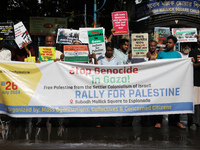 Indians for Palestine group members are holding posters during a protest, amid the ongoing conflict in Gaza between Israel and Hamas, in Kol...