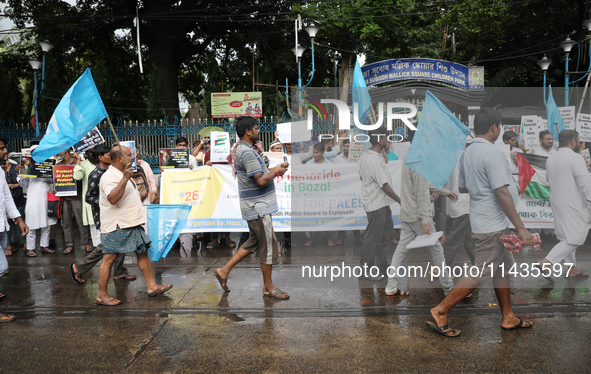 Indians for Palestine group members are holding posters during a protest, amid the ongoing conflict in Gaza between Israel and Hamas, in Kol...