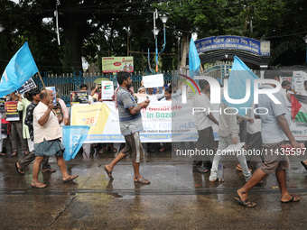 Indians for Palestine group members are holding posters during a protest, amid the ongoing conflict in Gaza between Israel and Hamas, in Kol...