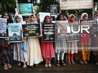 Indians for Palestine group members are holding posters during a protest, amid the ongoing conflict in Gaza between Israel and Hamas, in Kol...