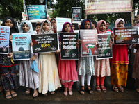 Indians for Palestine group members are holding posters during a protest, amid the ongoing conflict in Gaza between Israel and Hamas, in Kol...