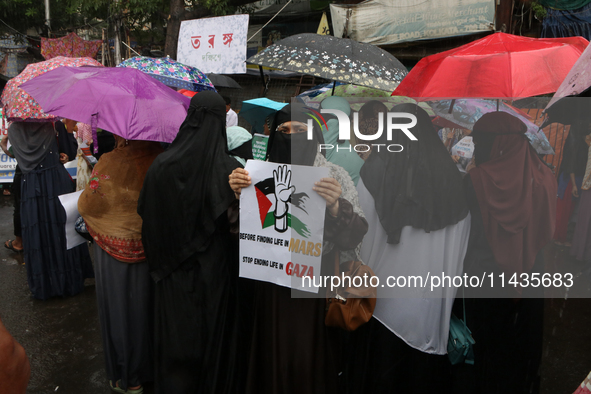 A Muslim woman is holding a poster during a protest rally, amid the ongoing conflict in Gaza between Israel and Hamas, in Kolkata, eastern I...