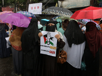 A Muslim woman is holding a poster during a protest rally, amid the ongoing conflict in Gaza between Israel and Hamas, in Kolkata, eastern I...