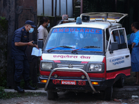 Dead body management staff at the morgue of Tribhuvan University Teaching Hospital are loading a body of the victim of the Saurya Airlines c...