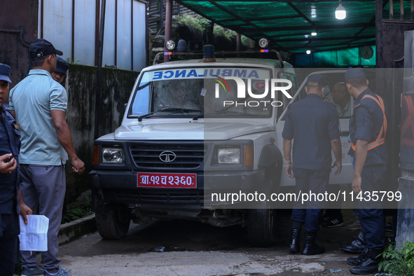 Dead body management staff at the morgue of Tribhuvan University Teaching Hospital are loading a body of the victim of the Saurya Airlines c...