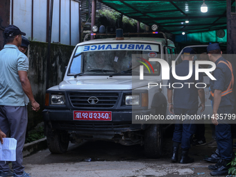 Dead body management staff at the morgue of Tribhuvan University Teaching Hospital are loading a body of the victim of the Saurya Airlines c...