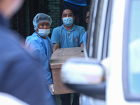 Dead body management staff at the morgue of Tribhuvan University Teaching Hospital are loading a body of the victim of the Saurya Airlines c...