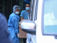 Dead body management staff at the morgue of Tribhuvan University Teaching Hospital are loading a body of the victim of the Saurya Airlines c...