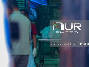 The body of a deceased in the Saurya Airlines crash is being wrapped in clothes to hand over to the family at the morgue in Kathmandu, Nepal...