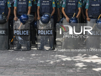 Bangladeshi Police are standing guard at the Baitul Mukarram National Mosque of Bangladesh, amid the anti-quota protests in Dhaka, Banglades...