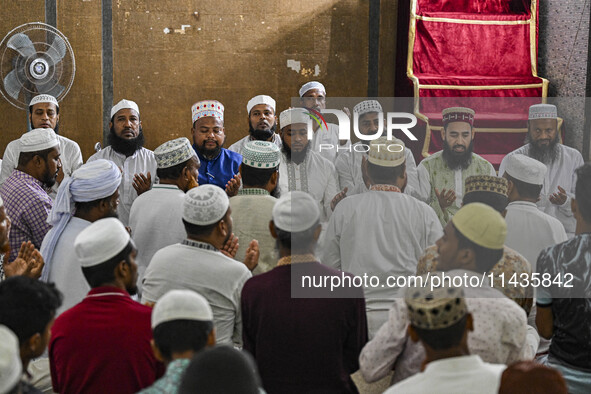 Bangladeshi Muslims are praying at a mosque for the deceased who died in indiscriminate killings and those injured during the anti-quota pro...