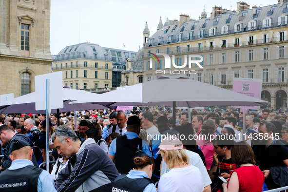 The first spectators of the opening ceremony of the Paris 2024 Olympic Games are passing through the police barrier that is searching every...