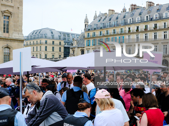 The first spectators of the opening ceremony of the Paris 2024 Olympic Games are passing through the police barrier that is searching every...