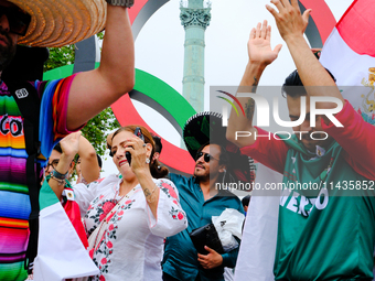 Mexican supporters of the Paris Olympics are taking pictures in the Place de la Bastille. (