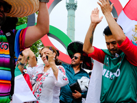 Mexican supporters of the Paris Olympics are taking pictures in the Place de la Bastille. (