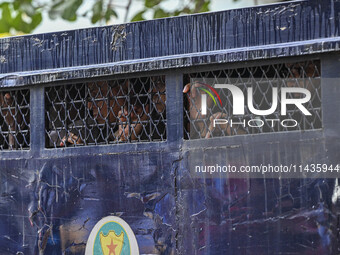 A police van is transporting protesters to the jail after their court hearing in Dhaka, Bangladesh, on July 26, 2024. The number of arrests...