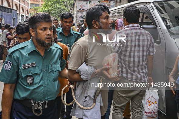 Police are taking protesters to the court after arresting them in Dhaka, Bangladesh, on July 26, 2024. The number of arrests in days of viol...