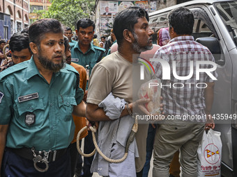 Police are taking protesters to the court after arresting them in Dhaka, Bangladesh, on July 26, 2024. The number of arrests in days of viol...