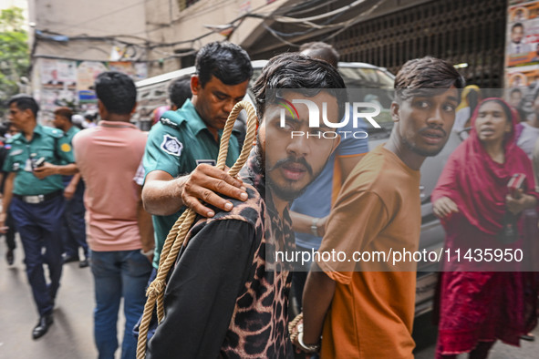 Police are taking protesters to the court after arresting them in Dhaka, Bangladesh, on July 26, 2024. The number of arrests in days of viol...