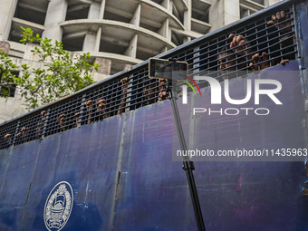 A police van is transporting protesters to the jail after their court hearing in Dhaka, Bangladesh, on July 26, 2024. The number of arrests...