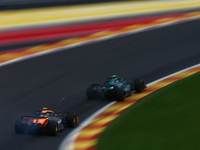 Fernando Alonso of Aston Martin Aramco and Lando Norris of McLaren during second practice ahead of the Formula 1 Belgian Grand Prix at Spa-F...