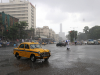 A Yellow Ambassador Taxi is riding in the heavy rainfall in Kolkata, India, on July 26, 2024. (