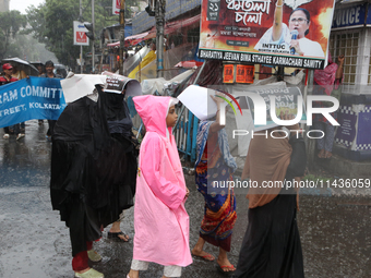 People are being seen during heavy rainfall in Kolkata, India, on July 26, 2024. (