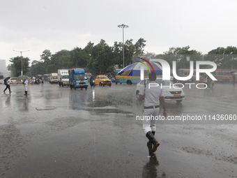 The police are holding umbrellas as they are walking in the monsoon rain in Kolkata, India, on July 26, 2024. (