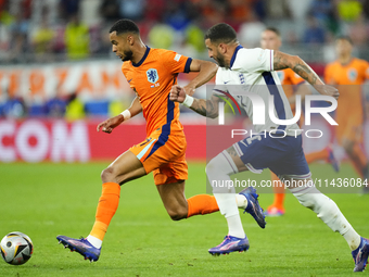 Cody Gakpo left winger of Netherlands and Liverpool FC and Kyle Walker right-back of England and Manchester City compete for the ball during...