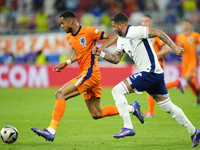 Cody Gakpo left winger of Netherlands and Liverpool FC and Kyle Walker right-back of England and Manchester City compete for the ball during...