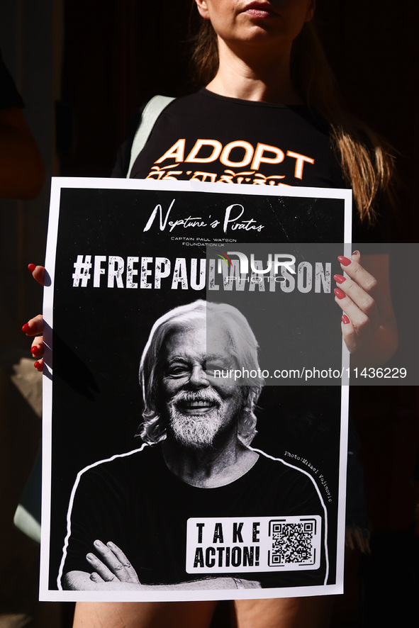 A person holds a banner during 'Free Paul Watson' demonstration in front of the Consulate General of Denmark in Krakow, Poland on July 26th,...