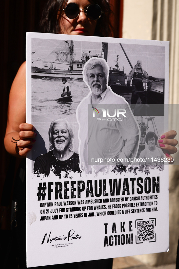 A person holds a banner during 'Free Paul Watson' demonstration in front of the Consulate General of Denmark in Krakow, Poland on July 26th,...