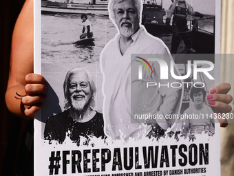 A person holds a banner during 'Free Paul Watson' demonstration in front of the Consulate General of Denmark in Krakow, Poland on July 26th,...