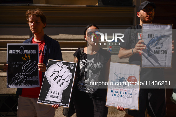 People hold banners during 'Free Paul Watson' demonstration in front of the Consulate General of Denmark in Krakow, Poland on July 26th, 202...