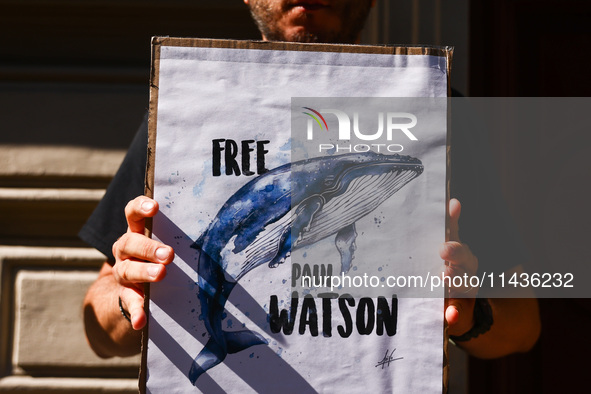 A person holds a banner during 'Free Paul Watson' demonstration in front of the Consulate General of Denmark in Krakow, Poland on July 26th,...