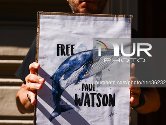 A person holds a banner during 'Free Paul Watson' demonstration in front of the Consulate General of Denmark in Krakow, Poland on July 26th,...