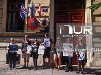 People hold banners during 'Free Paul Watson' demonstration in front of the Consulate General of Denmark in Krakow, Poland on July 26th, 202...