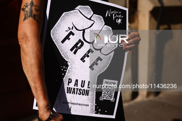 A person holds a banner during 'Free Paul Watson' demonstration in front of the Consulate General of Denmark in Krakow, Poland on July 26th,...