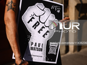 A person holds a banner during 'Free Paul Watson' demonstration in front of the Consulate General of Denmark in Krakow, Poland on July 26th,...