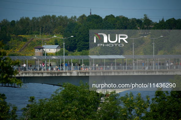 People are seen waiting to cross the border into Russia as seen from  Narva, Estonia on 24 July, 2024. Estonian authorities have closed the...