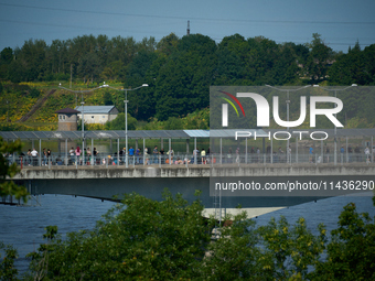 People are seen waiting to cross the border into Russia as seen from  Narva, Estonia on 24 July, 2024. Estonian authorities have closed the...